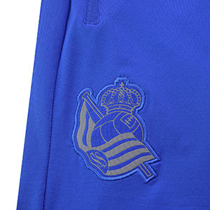 Pantalón chándal Macron Real Sociedad - Pantalón chándal Macron Real Sociedad  2019 2020 - azul - detalle escudo